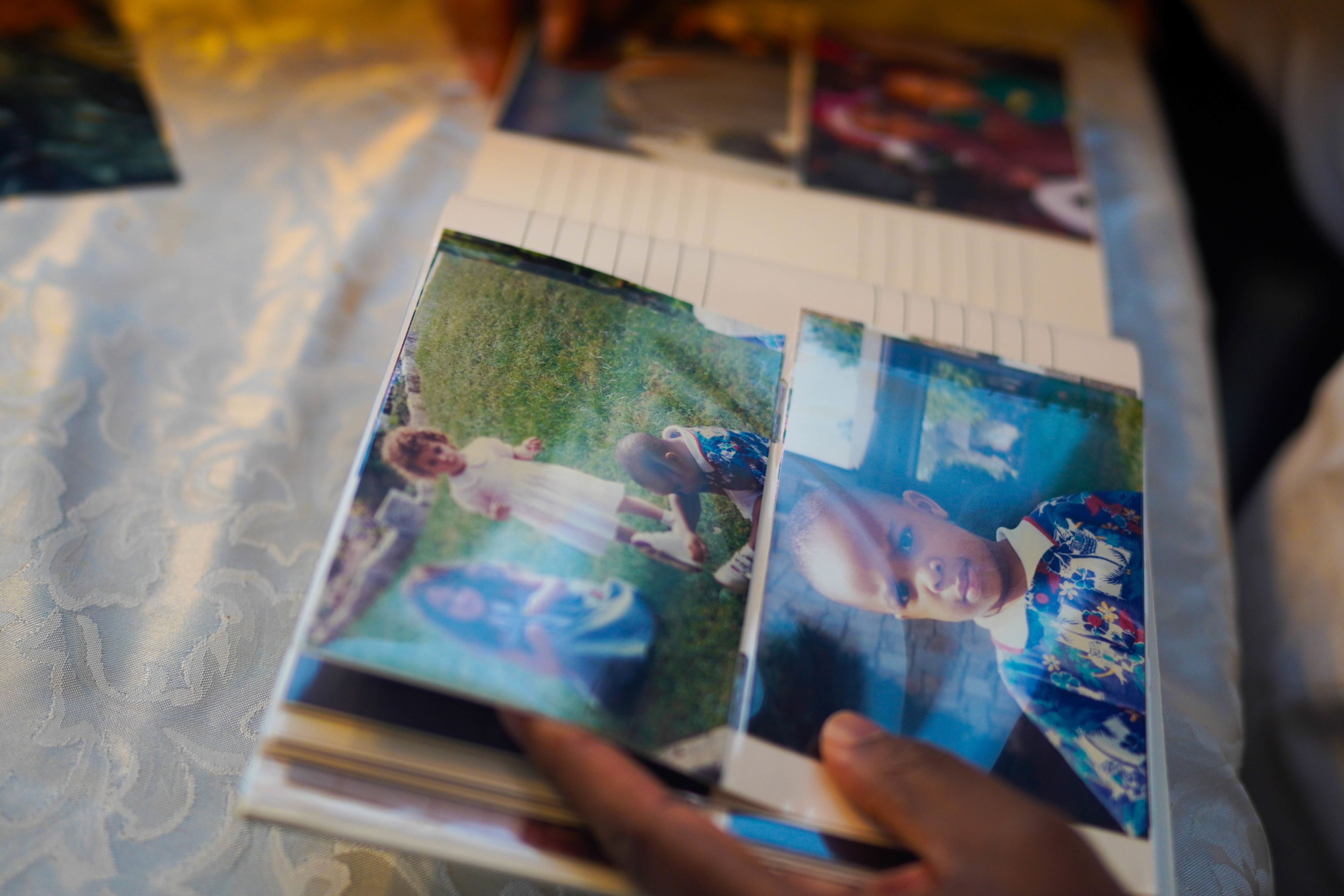 A photo book with hands turning the pages