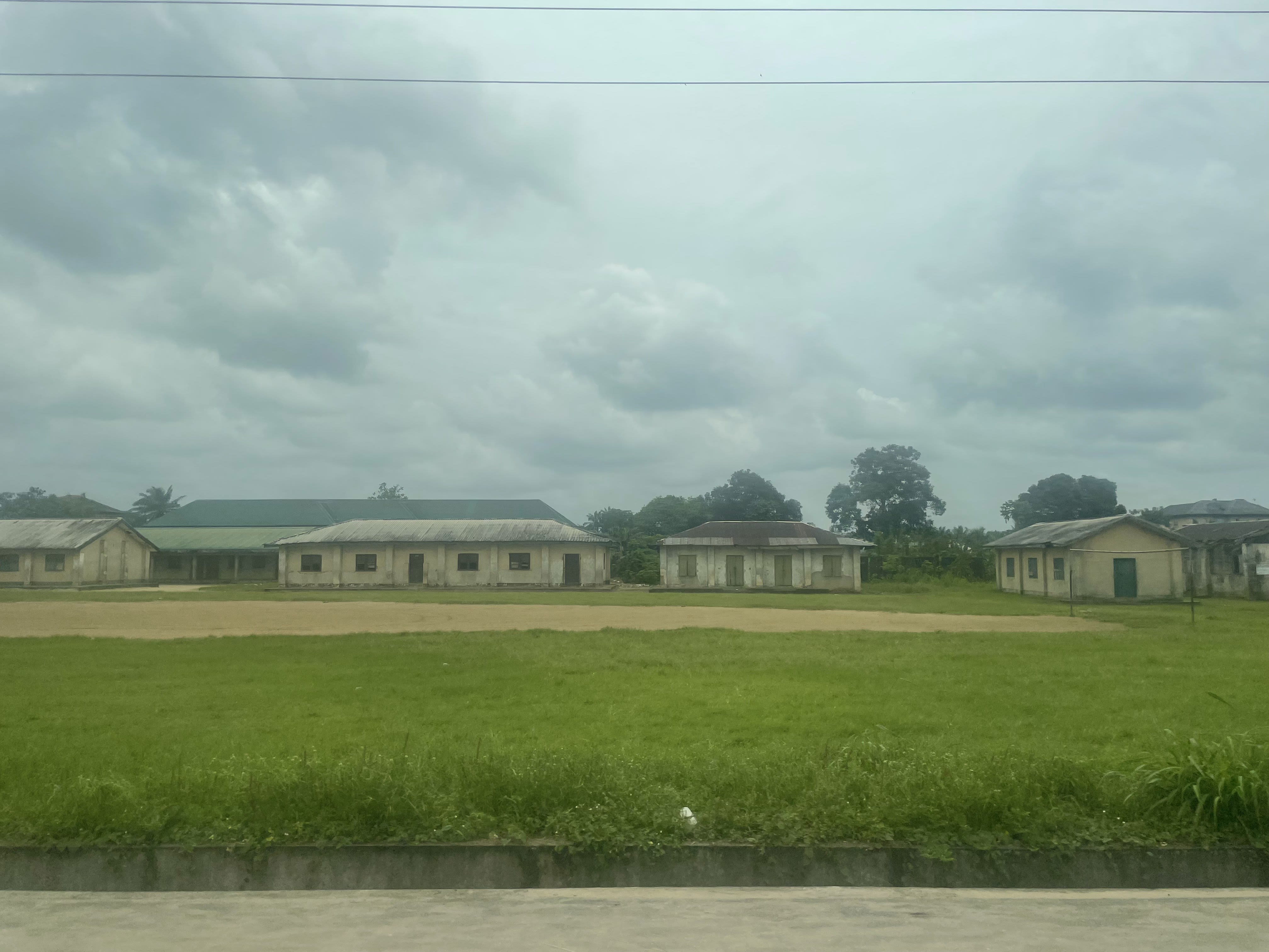 A row of old, cream-colored buildings under a grey sky.